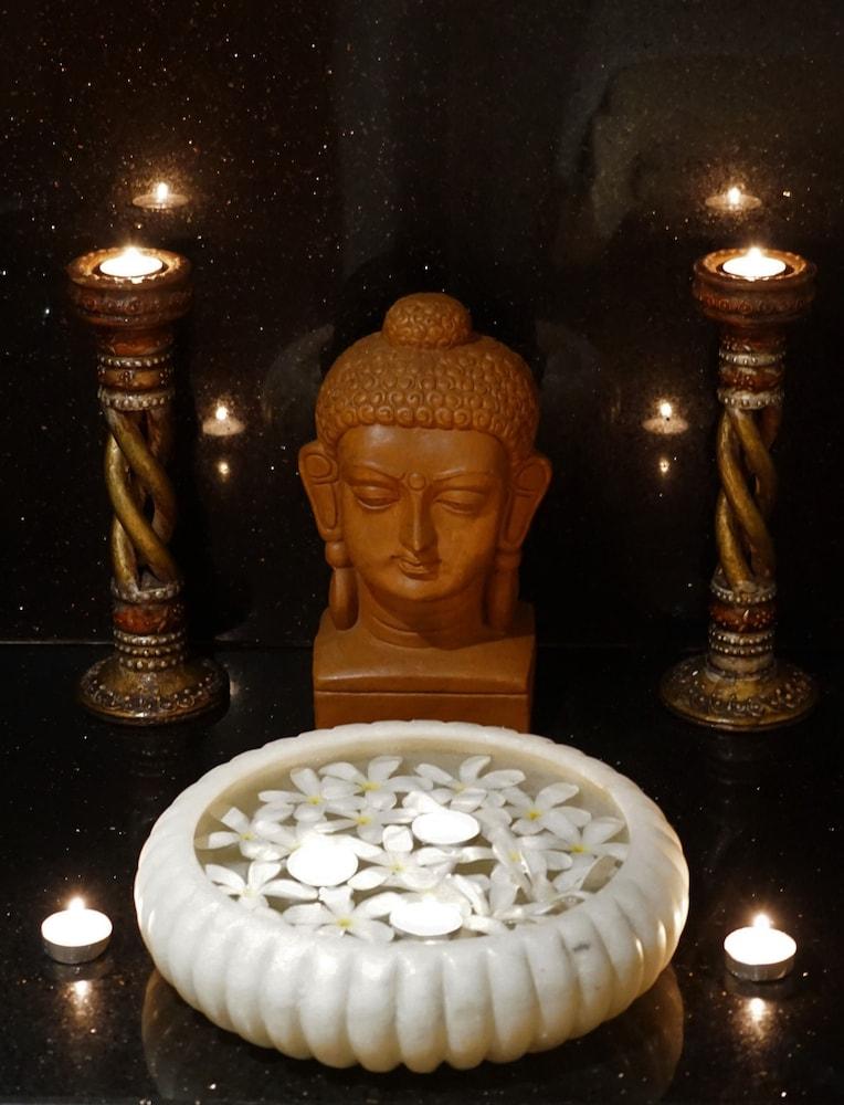 Taj Чандигарх Экстерьер фото A statue of the Buddha with two oil lamps